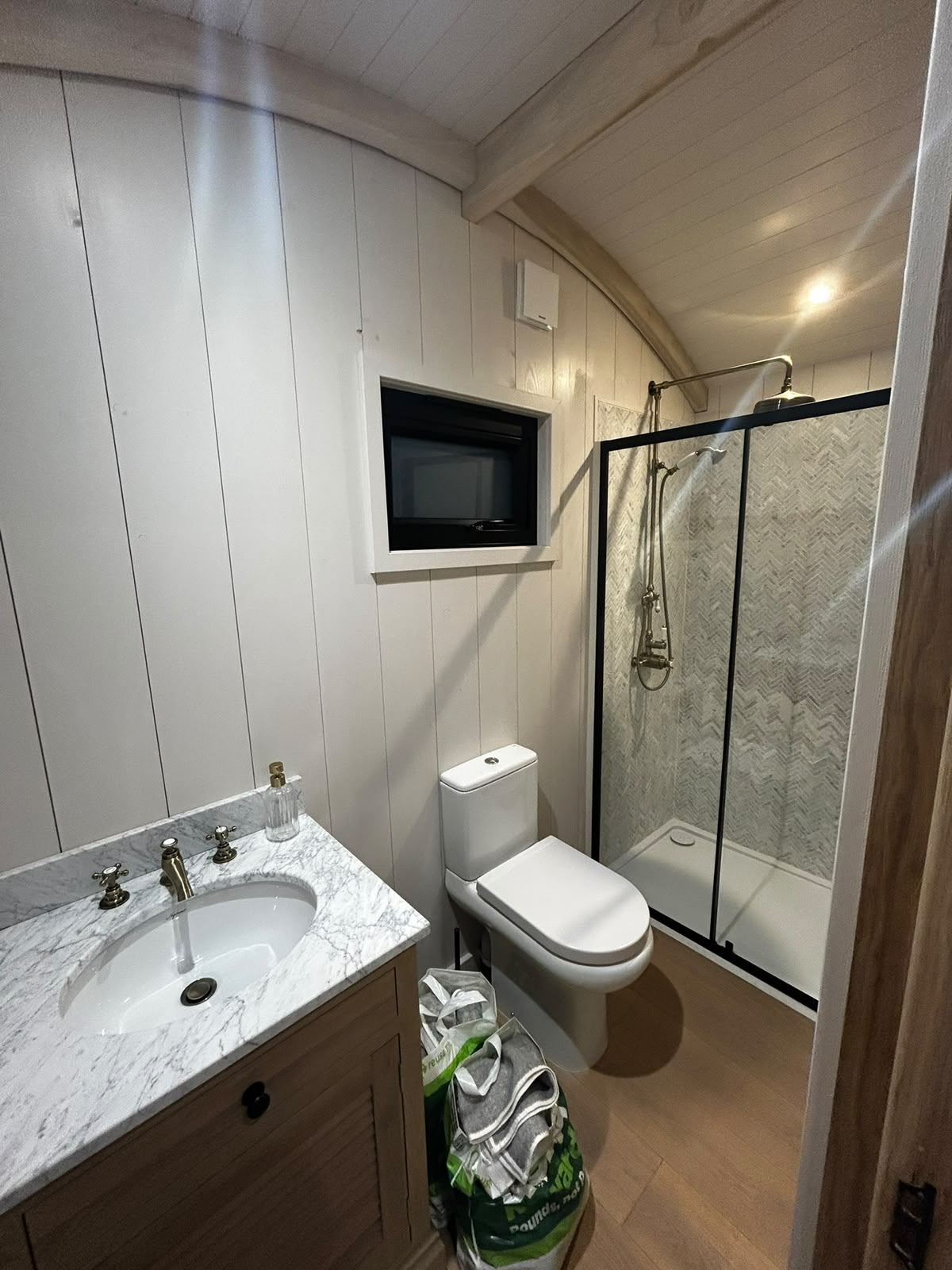 Bathroom with marble-topped vanity and glass shower
